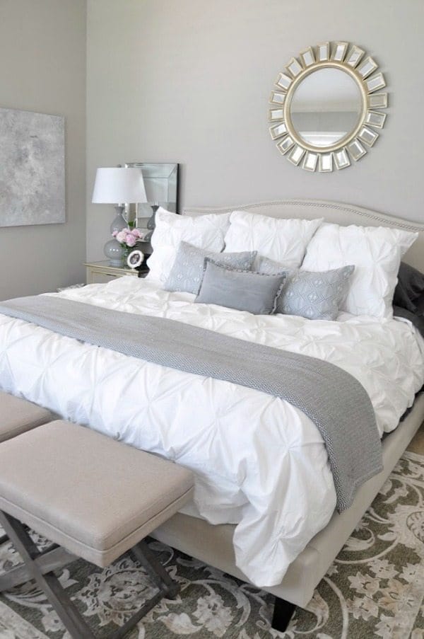 neutral master bedroom, white bedding with neutral rug grey accents, abstract art