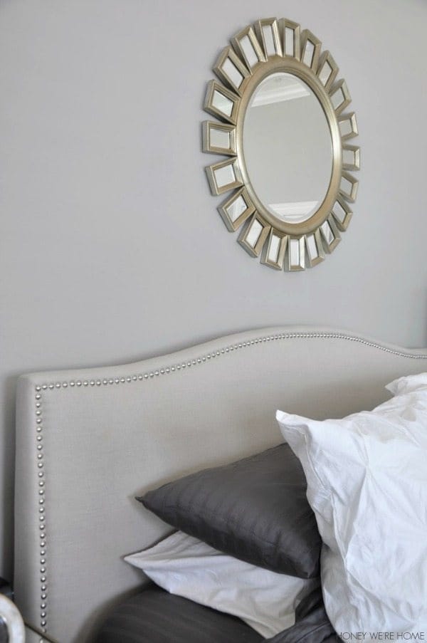 neutral master bedroom, gray and white bedding, white headboard, sunshine mirror w/gold 