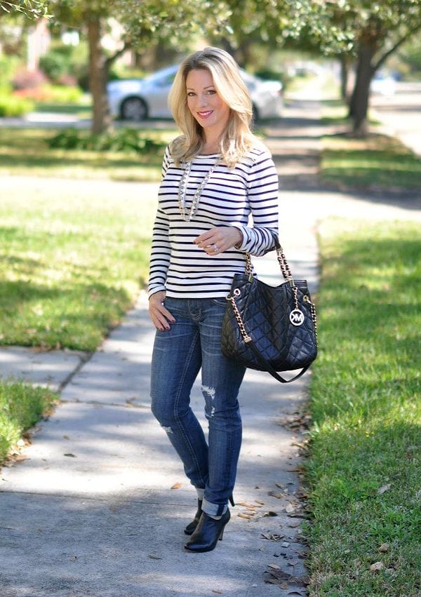 Fall fashion - distressed jeans, striped top, statement necklace, MK quilted bag, booties