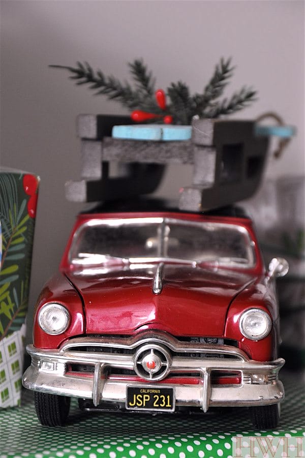 Festive holiday decor using real toys like this red car and sled ornament | Honey We're Home