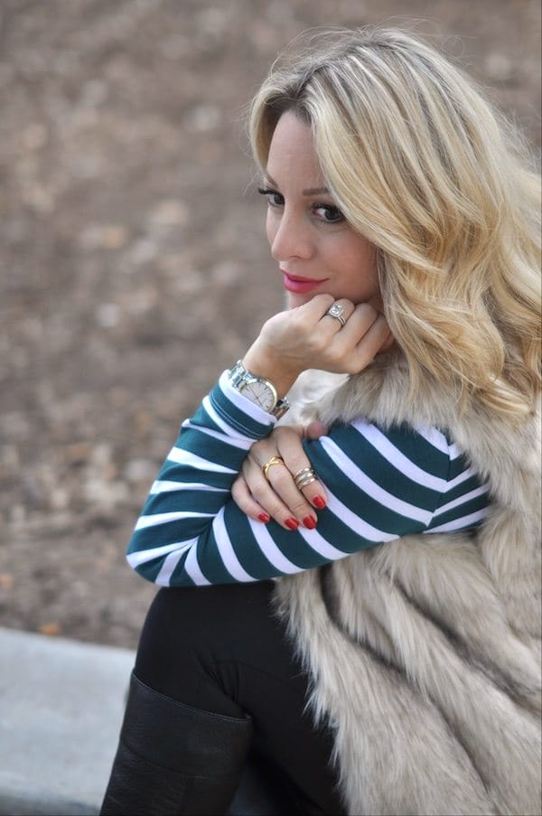Gorjana ring, faux fur vest, striped top, black maternity leggings, black boots, necklace and watch.