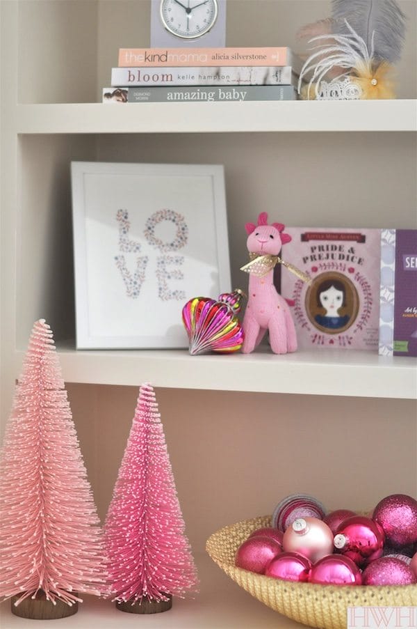 Festive holiday nursery with pink Christmas trees and ornaments in a bowl. | Honey We're Home