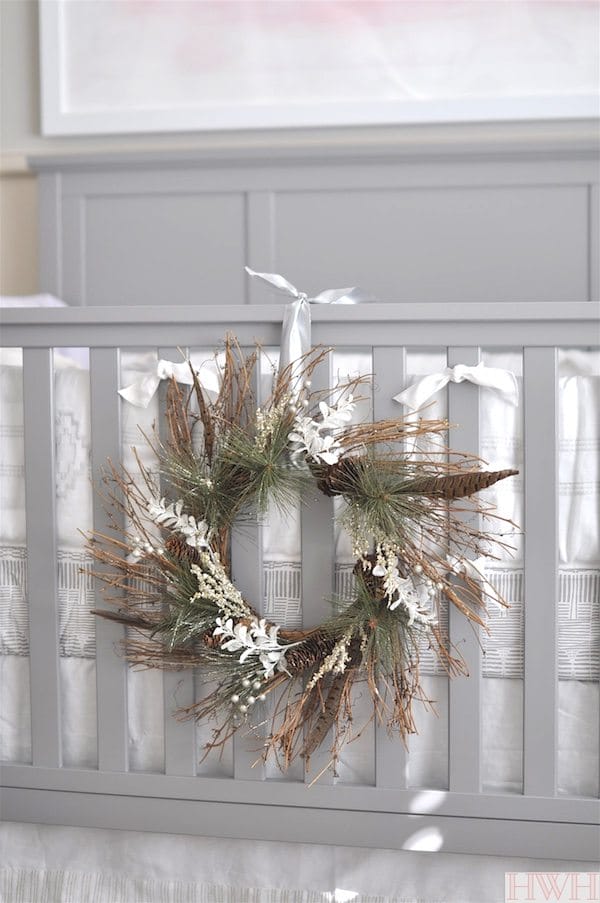 Pretty holiday wreath hung from crib in nursery.  Just lovely! | Honey We're Home