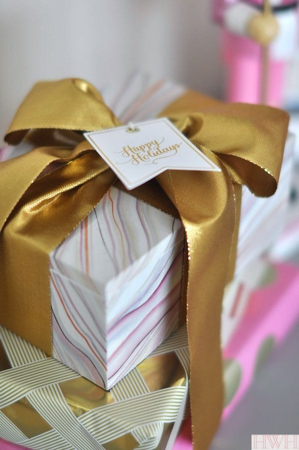 Pretty holiday packages with gold bow and sugar paper gift tags | Honey We're Home