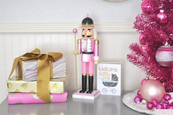Festive holiday nursery with pink tinsel christmas tree and pink nutcracker | Honey We're Home