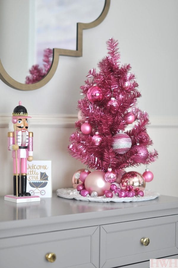 Festive holiday nursery with pink tinsel tree and pink nutcracker | Honey We're Home 