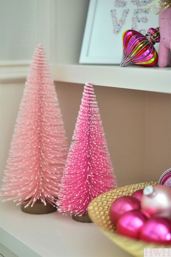 Festive holiday nursery with pink and gold decorations. Pink Christmas trees and ornaments in a bowl | Honey We're Home