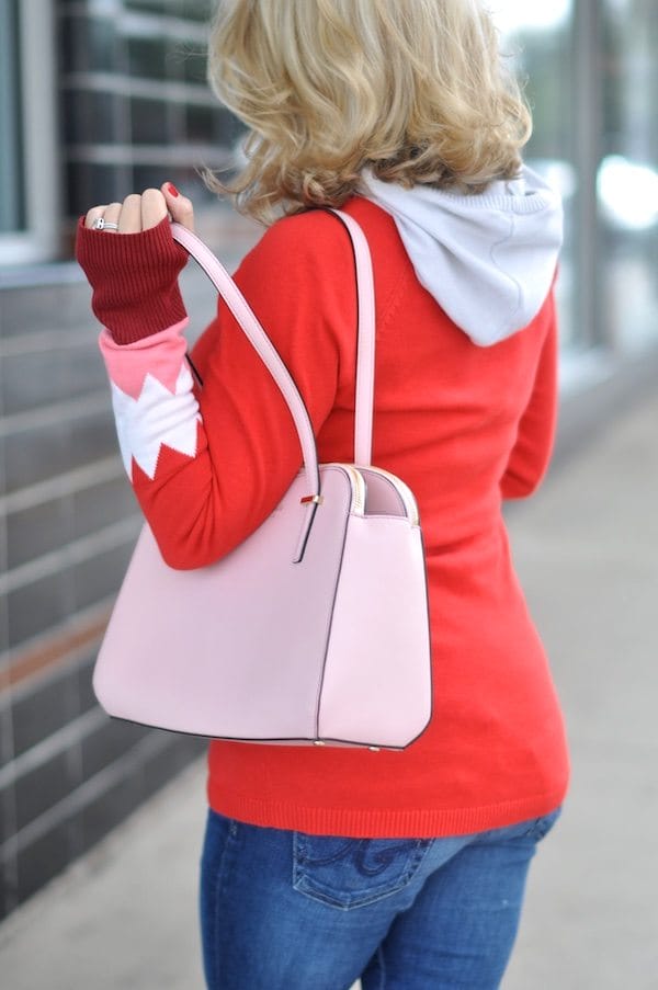 Festive red hooded sweater with pink and white on sleeves. Pink Kate Spade purse.