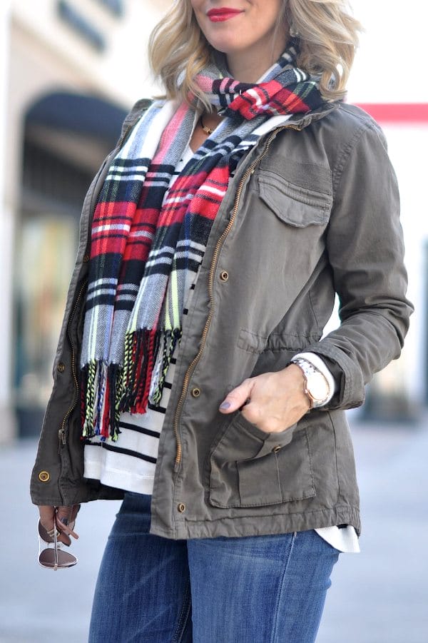Military style jacket, striped v-neck top and plaid scarf.
