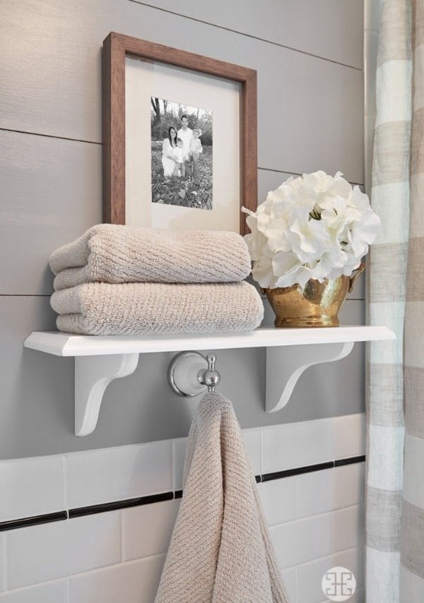Beautiful white open shelving in neutral bathroom | A Well Dressed Home 