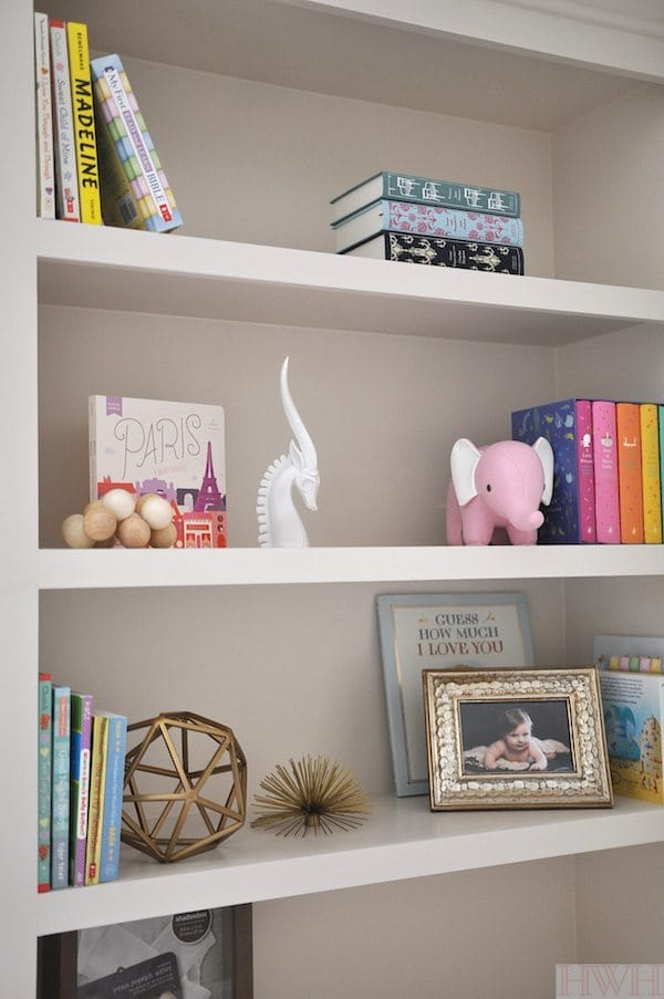 Nursery bookshelf with colorful accessories 