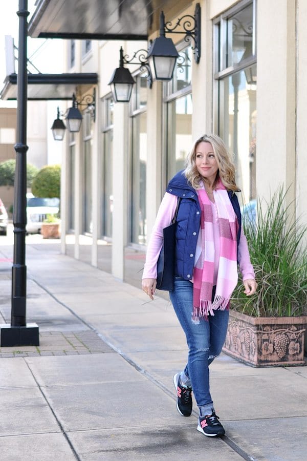 Fall/Winter fashion - distressed jeans, pink top, navy puffer vest and cute sneakers - cute weekend maternity outfit |  #dressingthebump #bumpstyle #maternitystyle