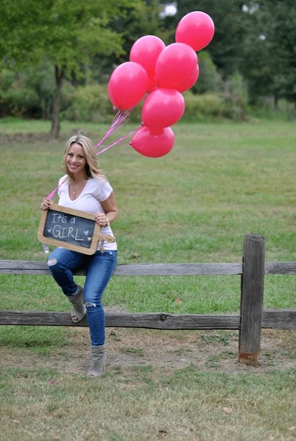 Gender reveal idea - It's a Girl with pink balloons and chalkboard sign 