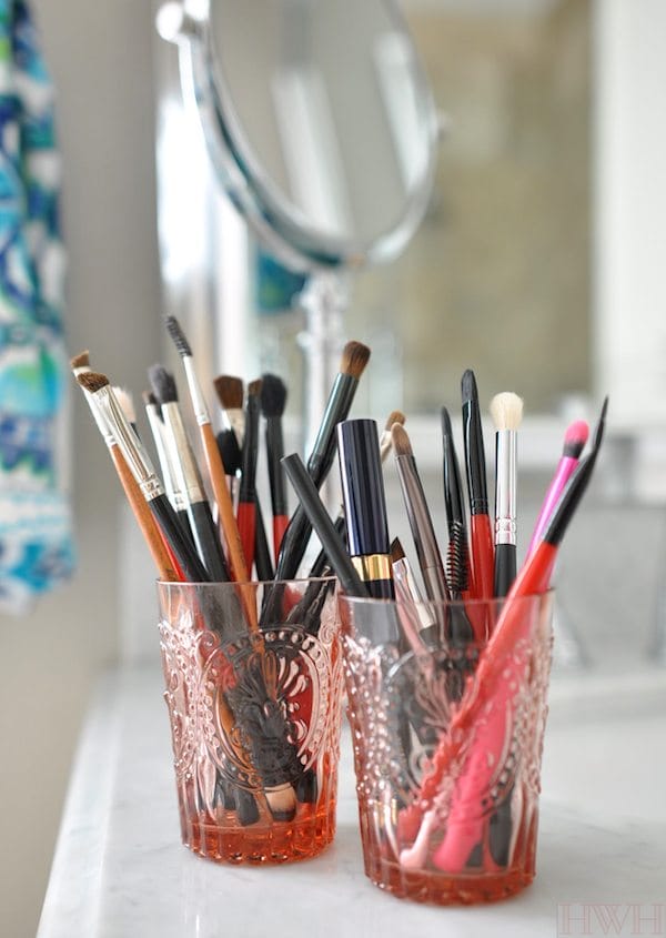 Clean makeup brushes stored upright in cute little glasses, easy to see and reach for what you need and keeps the bristles from getting mangled in a drawer