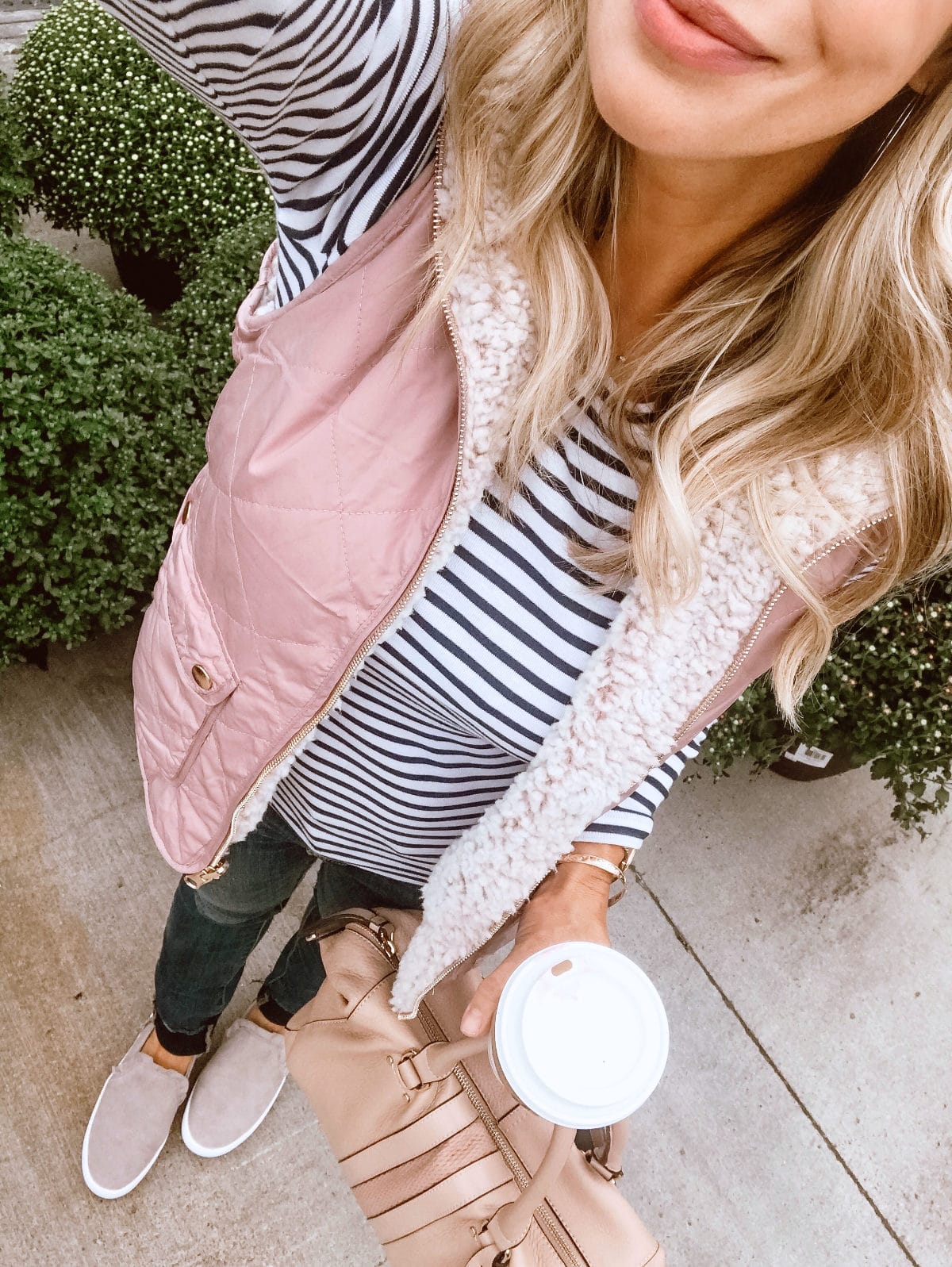 Fall Outfit Inspiration - puffer vest and striped top with jeans and sneakers