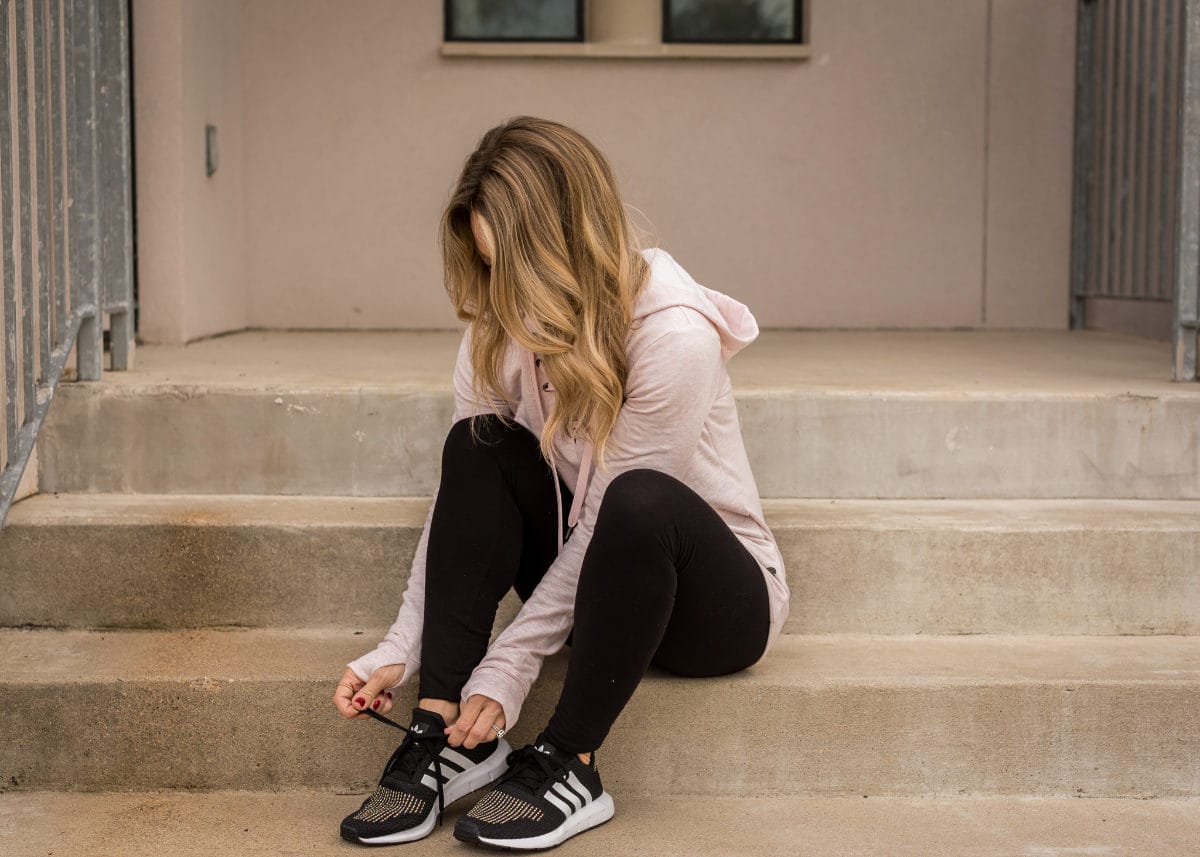 Cute Athleisure outfit with lace up hoodie and Adidas sneakers