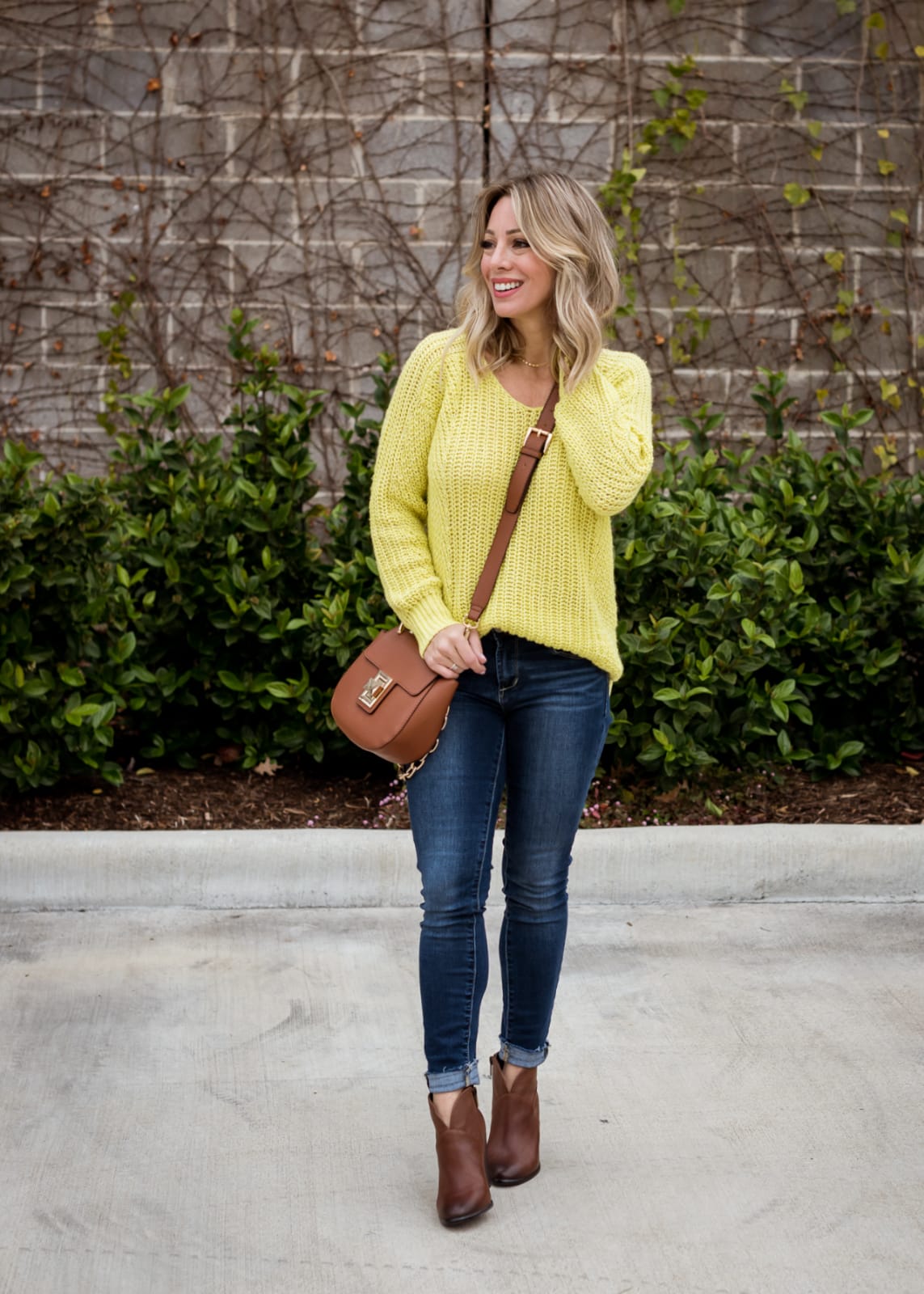 Cute winter outfit - yellow sweater and jeans with brown booties
