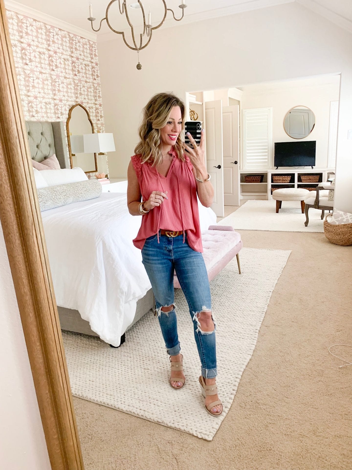 Pink smocked top and ripped knee jeans
