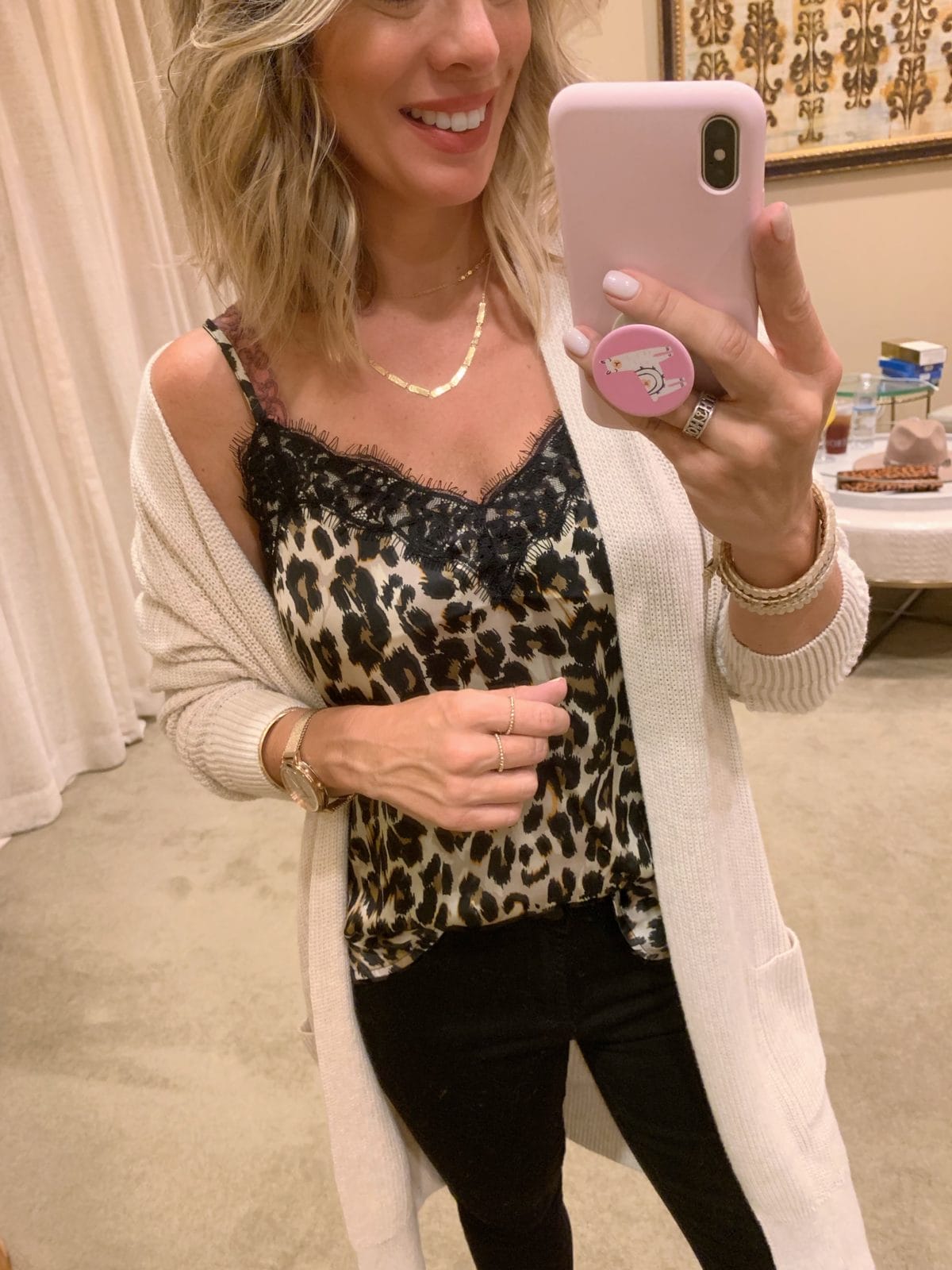 Nordstrom Anniversary Sale - leopard cami with a cream cardigan and black jeans with black boots
