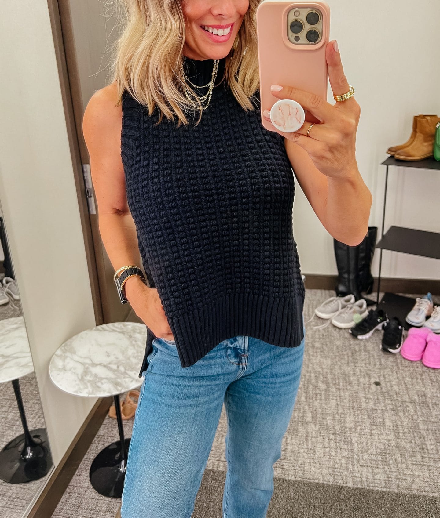 Nordstrom Anniversary Sale, black sleeveless turtleneck, blue jeans, black and silver sneakers, apple black and gold watchband, layered gold necklace