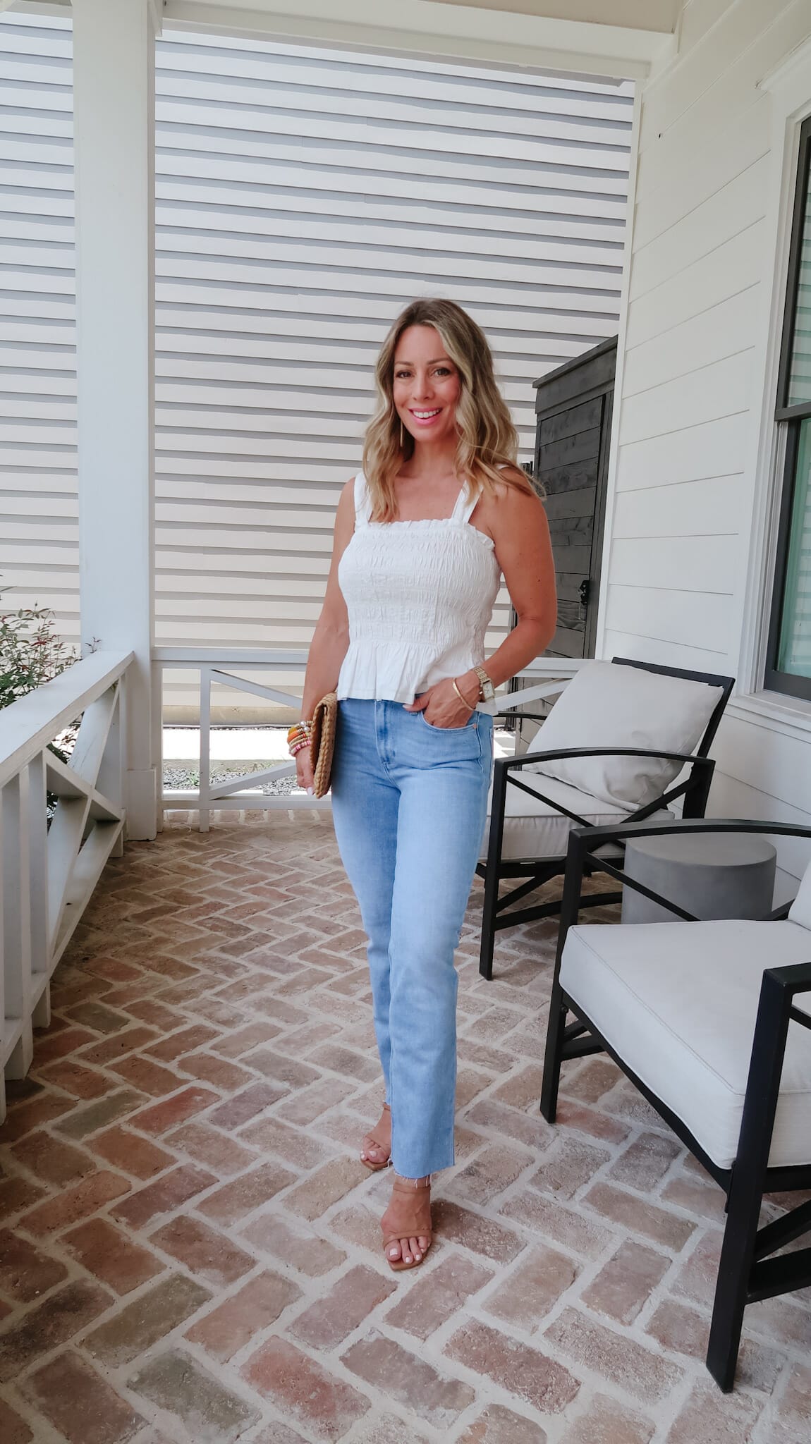 White Smocked Top, Jeans, Sandals. Clutch
